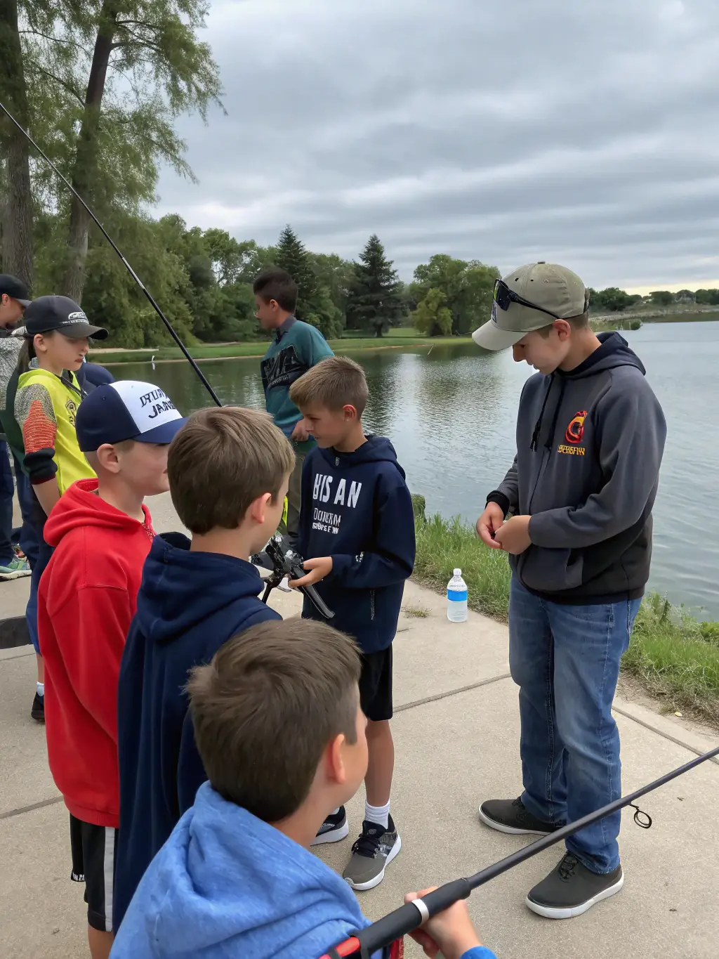 A photo of children participating in a fishing workshop, demonstrating the educational outreach program of AMICALE DES PECHEURS DU BLANZACAIS.